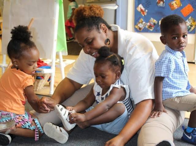 Children smiling and learning with care and support
